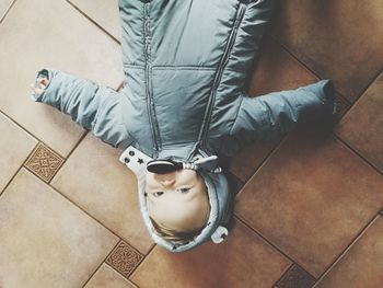 Low section of man sitting on tiled floor