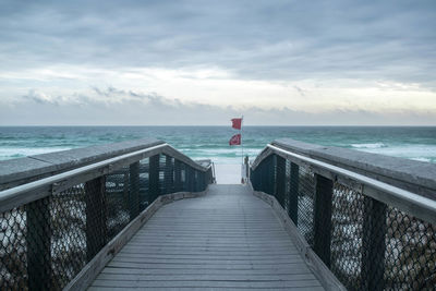 Pier over sea against sky