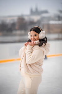 Portrait of cute girl standing against sky