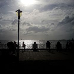 View of sea against cloudy sky at sunset