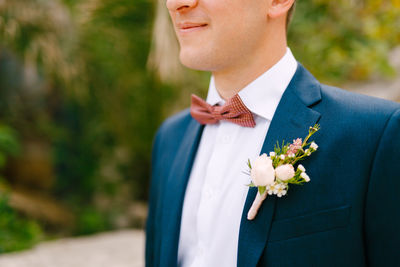 Midsection of man wearing suit outdoors