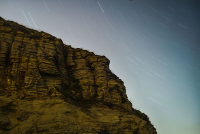 Low angle view of rock formation against clear sky at night