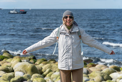 Portrait of young man standing at beach