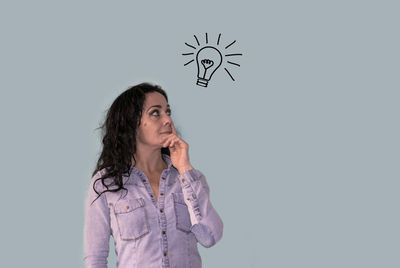 Mid adult woman standing against white background