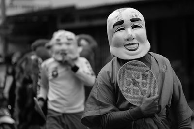 Close-up of man wearing mask during event