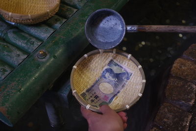 Washing a 1000 japanese yen note in a basket for prosperity in japan