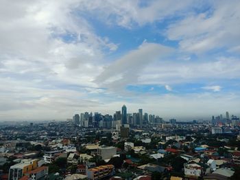 Cityscape against cloudy sky