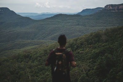 Woman looking at mountain landscape