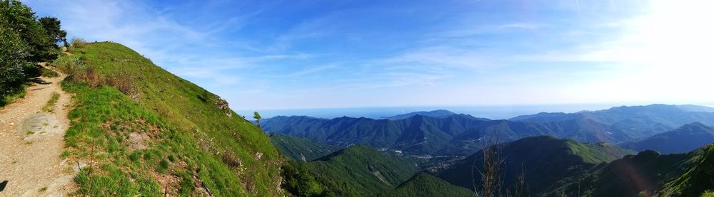 Panoramic view of mountains against blue sky