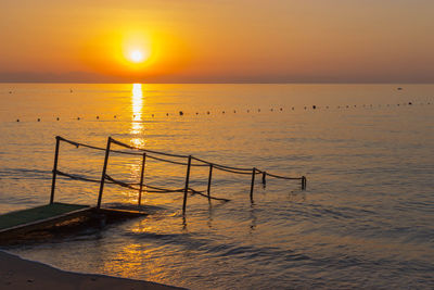 Scenic view of sea against orange sky