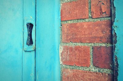 Close-up of blue door with brickwork 