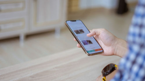 Midsection of woman using mobile phone