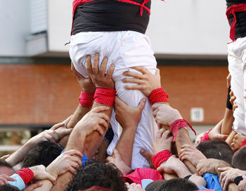 People holding man