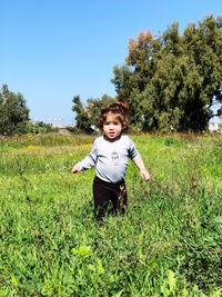 Portrait of young girl travels on field