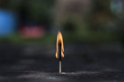 Close-up of burning matchstick