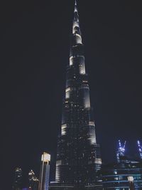 Low angle view of illuminated tower at night