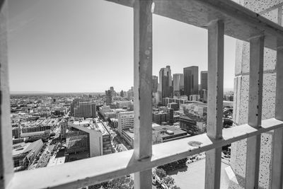 Buildings against clear sky seen through window