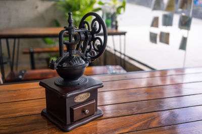 Close-up of machine part on wooden table