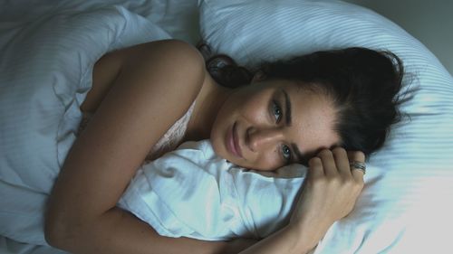 Portrait of a woman lying in bed