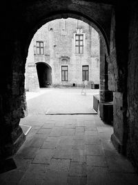 Empty alley amidst buildings in city