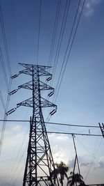 Low angle view of electricity pylon against sky