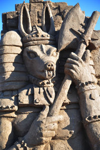 Statues on stone wall