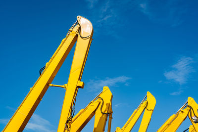 Low angle view of crane against sky