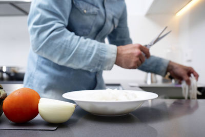 Midsection of man preparing food at table