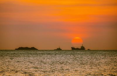 Scenic view of sea against orange sky