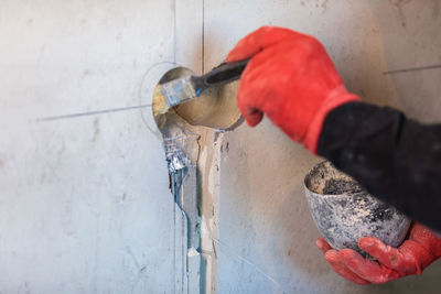 The electrician will prime the holes and channels for outlets and wires.