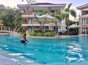 Rear view of man swimming in pool