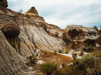 Low angle view of rock formation against sky