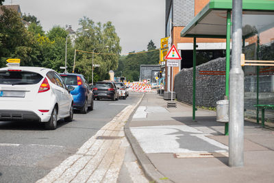 Cars on road by buildings in city