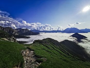 Scenic view of snowcapped mountains against blue sky