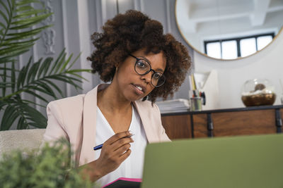 Young woman on video call through laptop in office