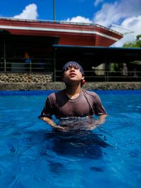 Portrait of man swimming in pool