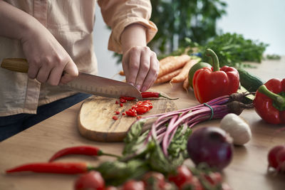 Midsection of man preparing food on table