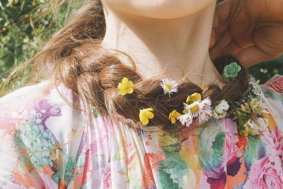 Close-up of young woman with flowers