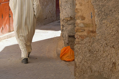 Low section of man standing on wall