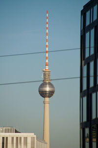 Low angle view of communications tower against sky