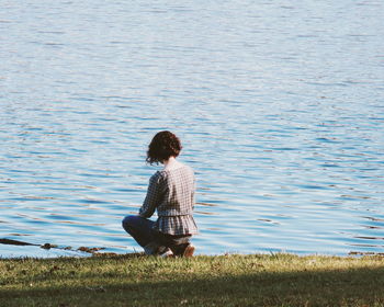 Rear view of woman looking at lake