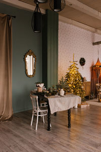Stylish christmas living room with a festive dining table decorated for christmas eve