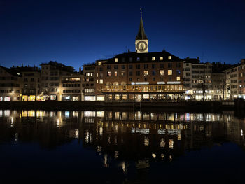 Reflection of illuminated buildings in water at night