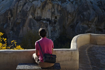 Rear view of woman sitting outdoors