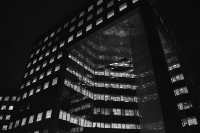 Low angle view of illuminated buildings against sky at night