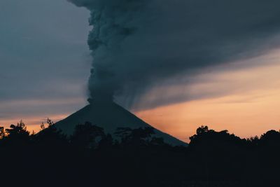 Scenic view of silhouette mountains against sky during sunset