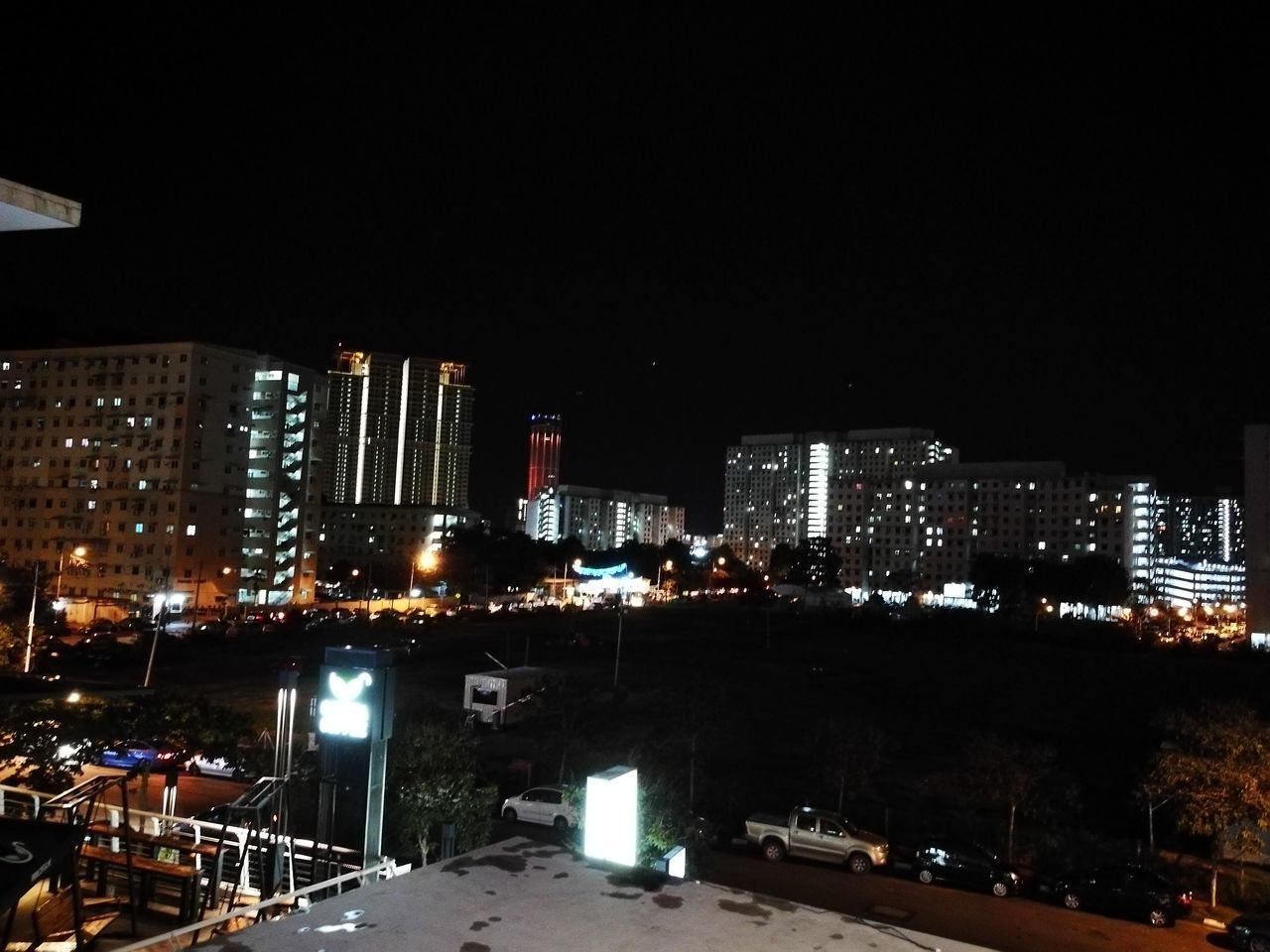 ILLUMINATED CITYSCAPE AGAINST SKY