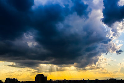 Low angle view of storm clouds over city