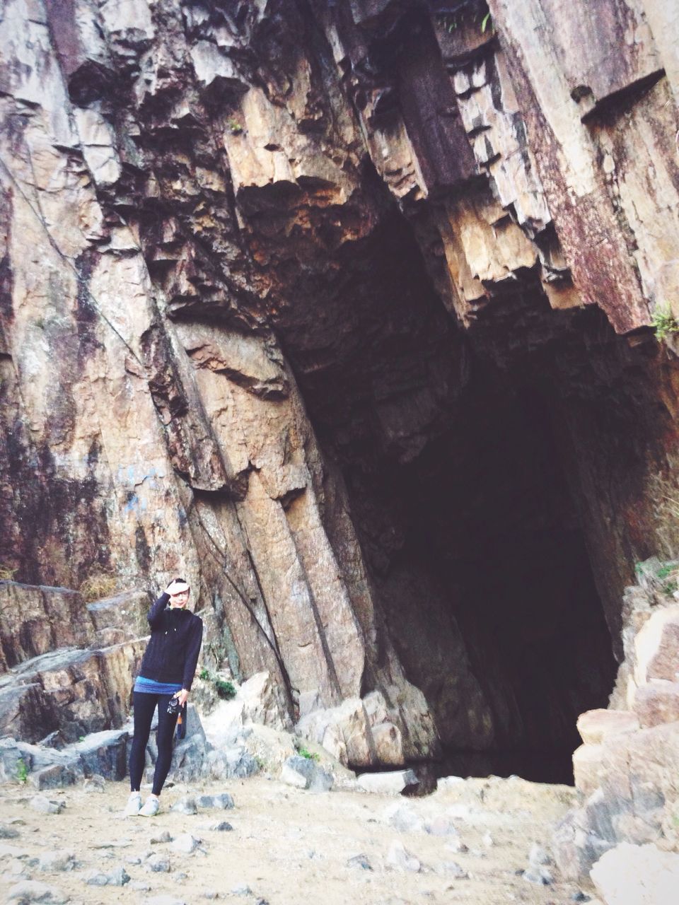 full length, lifestyles, leisure activity, rear view, men, architecture, built structure, rock - object, building exterior, walking, casual clothing, person, standing, rock formation, tourist, stone wall, day, outdoors