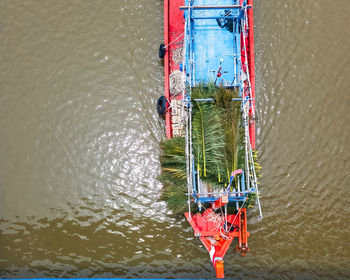 Top view of a boat moving with leaves on the river.